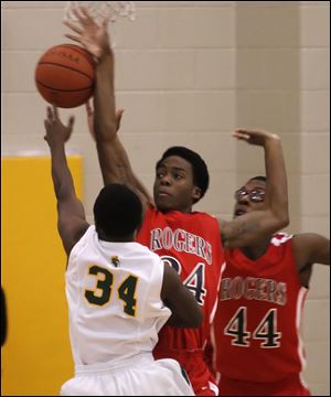 Rogers' Tribune Dailey blocks a shot of Start's David Cox. Dailey helped the Rams win their first City League title last season.