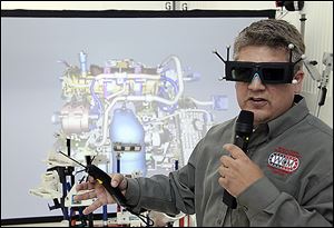 Tim Randolph demonstrates a simulator during a tour of Jeep. The Toledo automaker also was thrown into the 012 presidential race.