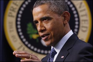 President Obama gestures as he speaks about the fiscal cliff in the South Court Auditorium at the White House in Washington. 