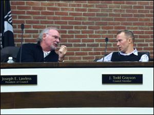 Perrysburg City Council president Joseph Lawless, left, speaks with councilman J. Todd Grayson prior to Wednesday's council meeting.