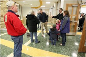 Brad Rieger, superintendent of Sylvania Schools, shakes hands with visitors at the new Central Trail Elementary on Saturday.