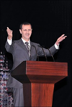 Syrian President Bashar Assad speaks to a cheering, chanting crowd at the Opera House in central Damascus. He offered a new peace plan during Sunday’s address. 