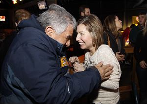 Josie Langsdorf, who is dealing with advancing lung cancer, jokes with her uncle, Raymond Gonzalez, during an impromptu party at Buffalo Wild Wings in Maumee.