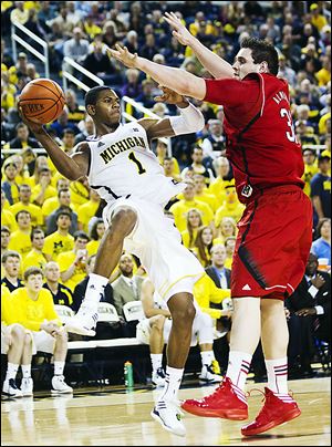 Michigan's Glenn Robinson III passes against Nebraska's Andre Almeida. The Wolverines play Sunday at Ohio State.