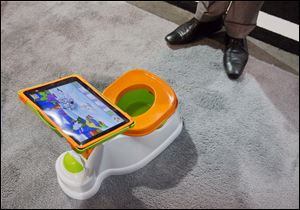 The iPotty for iPad potty training device is see on display at the Consumer Electronics Show, Wednesday, Jan. 9, 2013, in Las Vegas. No app is available to go with the trainer, but the idea is to keep the child on the toilet for as long as necessary by keeping them digitally entertained.