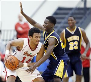 Whitmer's Jon Ashe (22) defends Central Catholic's DeShone Kizer (14) during a game Friday.