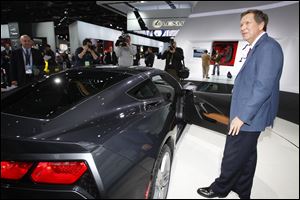 Ohio Gov. John Kasich takes a close look at the new Corvette Stingray at the North American International Auto Show in Detroit. He met with auto leaders there.