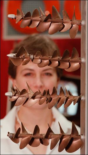 The beryllium industry has marketed its strong, lightweight metal for consumer products ranging from golf clubs to sunglasses to toys. At a toy fair last year, Trudi Handzel of Chicago looks at a display of beryllium copper propellers at the SeaGate Centre in Toledo.