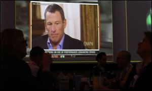 A video screen at a hotel restaurant in Grapevine, Texas, shows a replay telecast of a segment of Lance Armstrong being interviewed by Oprah Winfrey.