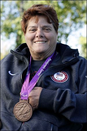 Zena Cole, of Oregon, poses at Pearson Metropark with her bronze medal which she won for the discus throw at the 2012 Paralympics in London.