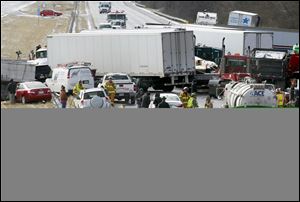 Semi-trucks and other vehicles involved in a mulit-car crash are strewn across westbound Interstate 275 between Colerain Avenue and Hamilton Avenue in Cincinnati.