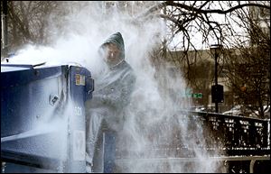 Kevin Miller drives the Zamboni at the Nibco Ice and Water Park in  Elkhart, Ind., on Tuesday, a day that made outdoor work a bigger challenge than normal. 