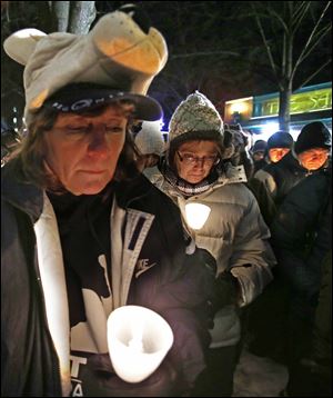 People attends a candlelight memorial on the first anniversary of the death of former Penn State head football coach Joe Paterno, Tuesday in State College, Pa.