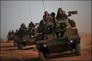 French soldiers patrol in armored vehicles, in the outskirts of Sevare, Mali, some 620 kms (385 miles) north of Bamako.