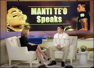 Notre Dame linebacker Manti Te'o, right, speaking with host Katie Couric during an interview for 