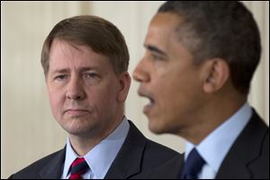 Richard Cordray stands left as President Obama announces that he will re-nominate Cordray to lead the Consumer Financial Protection Bureau, a role that he has held for the last year under a recess appointment.