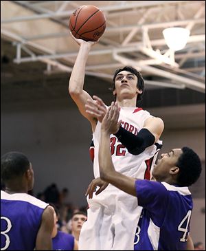 Bedford's Jackson Lamb takes a shot against Ann Arbor Pioneer's Tevis Robinson during their game Friday night in Bedford. Lamb scored 24 points, grabbed 10 rebounds, and blocked four shots.