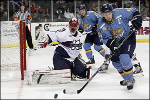 Toledo's Kyle Rogers looks to pass after a shot on goal was deflected by Kalamazoo goalie Joel Martin during the third period.