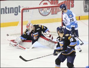 Walleye goalie Jordan Pearce made 30 saves, including this one in the third period, to help Toledo to a 4-1 win — its second straight. Looking on is Toledo's Joey Ryan, and Evansville's Josh Beaulieu.