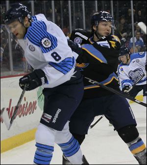 Evansville's TJ Miller is pushed aside by Toledo's Adam Hobson in the first period on Sunday. Miller played for the Walleye for three games earlier this month before being released.