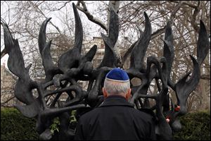 A Jewish man stands in front of  the Holocaust Memorial commemorating the persecution of the Jewish people during World War II in Thessaloniki, northern Greece. There were some 50,000 Jews living in Thessaloniki at the start of World War II, and almost 45,000 perished at Auschwitz concentration camp. Greece officially commemorates the Holocaust every Jan. 27.(AP Photo/Nikolas Giakoumidis)