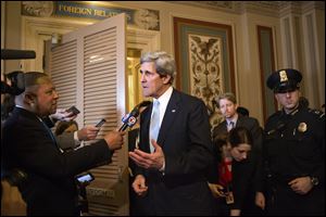 Sen. John Kerry, D-Mass., speaks briefly to reporters as he emerges after a unanimous vote by the Senate Foreign Relations Committee approving him to become America's next top diplomat, replacing Secretary of State Hillary Rodham Clinton, on Capitol Hill in Washington.