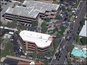 This frame grab provided by abc15.com shows the scene at a Phoenix office complex where police say someone shot at least three people today.