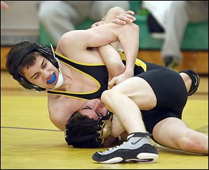 Clay's Colixtro Mongragon pins Perrysburg's Nathan Meyers in 50 seconds in the 120-pound match during the Division I regional semifinals.