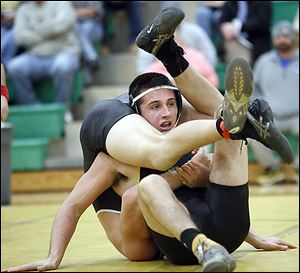 Clay's Ed Silva defeats Perrysburg's Kadin Llewellyn in the 195-pound match. Silva won 13-0.