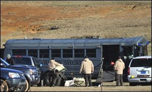 Law enforcement personnel load provisions into a bus during the third day of a hostage crisis involving a 5-year-old boy, in Midland City, Ala.