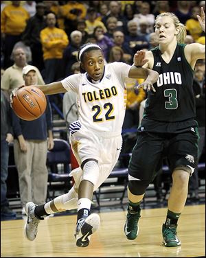 Andola Dortch drives inside against Ohio University player Erin Bailes en route to a UT win against Ohio.  Dortch was injured early in the second half when her knee bent backward, but apparently will be fine. 