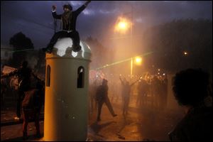 Anti-government protesters gather outside Egypt's presidential palace in Cairo, today.