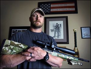 Chris Kyle, former Navy SEAL and author of the book American Sniper, poses in Midlothian, Texas. Eddie Ray Routh of Lancaster was arraigned early Sunday in the deaths of Kyle, 38, and Chad Littlefield, 35, at a shooting range at Rough Creek Lodge, Texas, about 50 miles southwest of Fort Worth. He was being held on one charge of capital murder and two charges of murder.