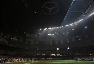 Players huddle on the field during a Superdome power outage in the second half of Super Bowl XLVII, Sunday, in New Orleans.