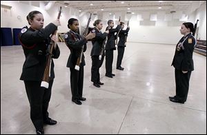 Cadet Major Ashley Balla, right, leads Junior ROTC drill team members, from left, Christina Yeakle, Mariah Coleman, Mackenzie Shiple, Issa Amad, and Devonte Fountain, in a drill at Springfield High School in Holland.  The team has been chosen to participate in a national competition in Louisville. 