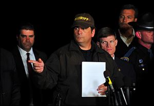 Dale County Sheriff Wally Olsen talks with reporters in Midland City, Ala., Monday. Authorities stormed an underground bunker Monday, freeing a 5-year-old boy who had been held hostage in the tiny underground shelter and leaving the boy's abductor dead.