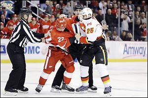 Detroit's Jordin Tootoo (22) battles Calgary Flames center Steve Begin in a fight during the first period.