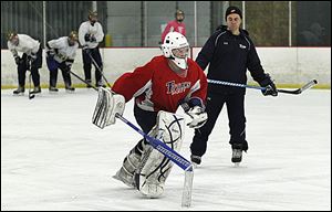 St. John's coach Mike Hayes watches goaltender Mike Barrett skate at practice. Barrett has a 1.67 goals-against average and a .929 save percentage.