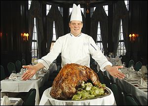 Toledo Club Chef Michael Rosendaul shows off a roasted wild boar, one of the many featured meats, at the annual Wild Game Dinner on Thursday night enjoyed by about 250 diners.