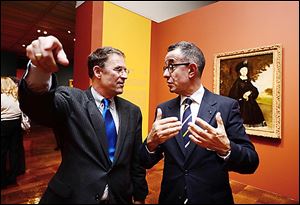 Larry Nichols, left, co-curator of 'Manet: Portraying Life,' consults with Colin B. Bailey, chief curator of the Frick Collection, New York City, during a donor preview of the exhibition at the Toledo Museum of Art.