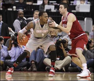 Ohio State's Deshaun Thomas, left, posts up against Indiana's Will Sheehy during the second half of an NCAA college basketball game in Columbus. Indiana defeated Ohio State 81-68. 