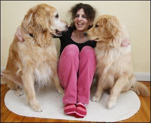 Madalyn Ruggiero is with her golden retrievers, Denali, left, and Sir Wilbur. Denali was diagnosed with nasal cancer last fall.