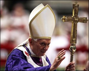 Pope Benedict XVI greets the faithful at the end of the Ash Wednesday mass in St. Peter's Basilica at the Vatican.