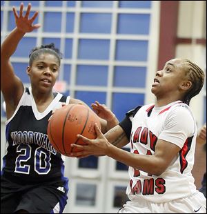 Rogers' Cha'Ron Sweeney goes to the basket against Woodward's Mylisha Fitchpatric during a City League semifinal at Scott High School. Sweeney led the Rams with 14 points despite spending a lot of time on the bench after Rogers built a big early lead against the Polar Bears.