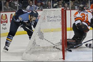 Toledo's Randy Rowe taps the puck in the third period for what became the game winner against Fort Wayne goalie Charlie Effinger.