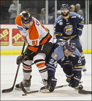 Toledo's Byron Froese (24) battles Fort Wayne's Colin Chaulk (91) for control of the puck during the third period.