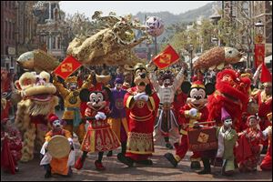 Mickey mouse and other cartoon characters pose during a parade as celebrating the Chinese New Year in 2008.