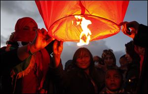 Libyans release a lantern in the air at Nasr Square during  a celebration of the ouster of Moammar Gadhafi in Benghazi, Libya. The uprising that eventually toppled the longtime dictator began two years ago.