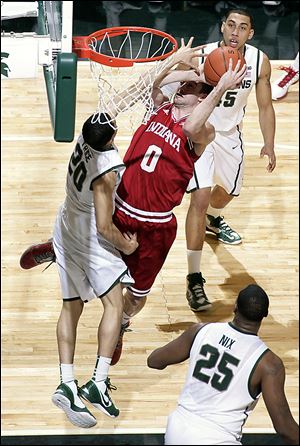 Indiana's Will Sheehey shoots over Michigan State's Travis Trice (20) as Derrick Nix (25) and Denzel Valentine watch during the first half on Tuesday.