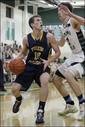 TC's Josh Winzeler drives against Ottawa Hills' Geoff Beans. Winzeler averages 10.1 points and 5.9 rebounds.